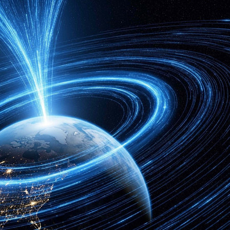 A stunning visual of blue light trails swirling around the Earth in space with illuminated city lights visible at nightの写真素材