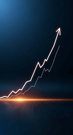 A glowing white line graph shows a steady upward trend on a dark blue background with a bright lightの写真素材