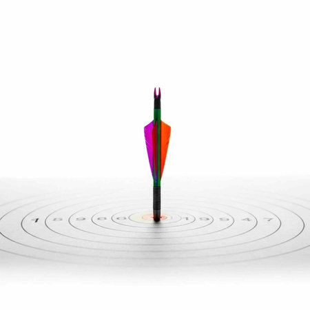 Multicolored arrow hits center of dartboard target with concentric circles and numbers on white backgroundの写真素材