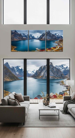 A modern living room with large windows, gray couches, and mountain view artwork on the wall and in the backgroundの写真素材