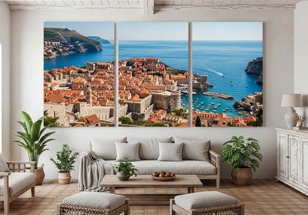 A serene living room with a large triptych coastal cityscape artwork, minimalist furniture, and lush green plantsの写真素材