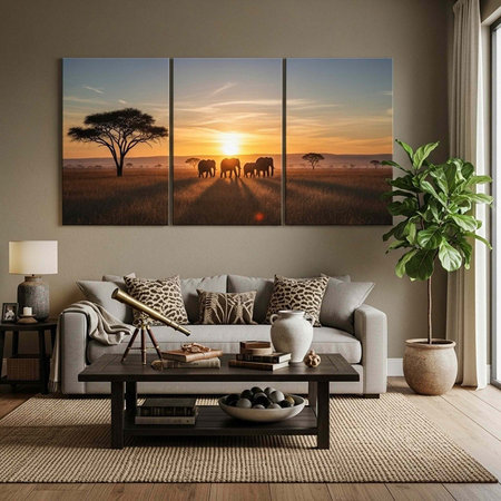 A stylish living room with a gray couch, a triptych African sunset painting, and a coffee table with decorative itemsの写真素材