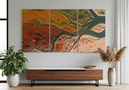 A modern room with a triptych abstract art piece, wooden credenza, and potted plants on a wooden floorの写真素材