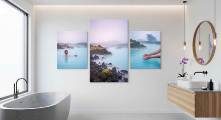 A sleek, modern bathroom with a freestanding bathtub, large window, and wooden vanity, featuring triptych ocean artworkの写真素材