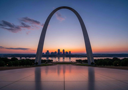 The iconic Gateway Arch stands tall against a vibrant sunset backdrop in St. Louis, Missouri, overlooking the city skyline.