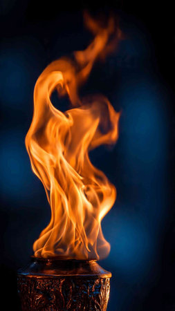 Burning torch on a dark blue background. Close-up.