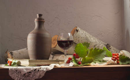 Still life with wine and mountain ashの写真素材