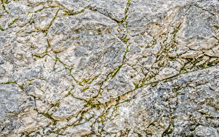 Natural stone (rock) wall with cracks
