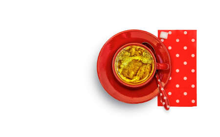 Red cup with coffee, red saucer, red spoon and paper napkin white dotted, white background, shot from aboveの写真素材