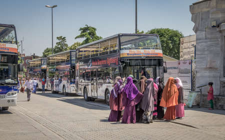 Istanbul, Turkey - June 14, 2012 - Sightseeing buses station in the Sultanahmet Square. A group of local tourists is waiting for hop on-hop off busのeditorial素材
