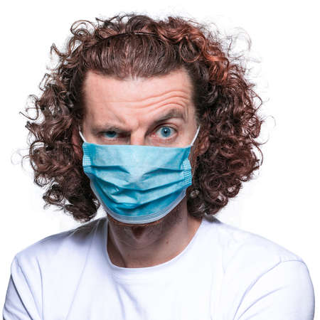 Man in medical mask. In fear of coronavirus 2019-ncov covid-19 concept.の写真素材