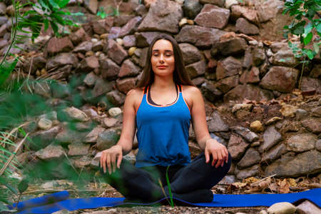 Young woman practicing yoga in the parckの写真素材