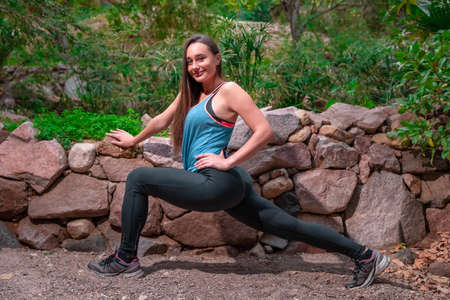 Young woman practicing yoga in the parckの写真素材