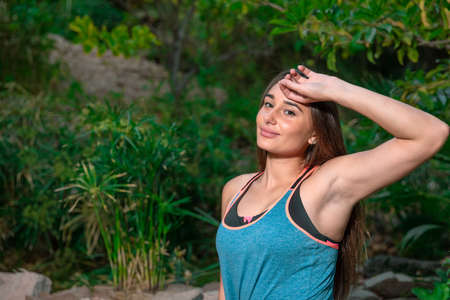 Young woman practicing and training yoga in the parck. Outdoor lady's sportの写真素材