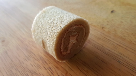 cake roll and coffee on wooden tableの写真素材