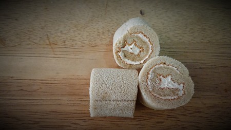 cake roll and coffee on wooden tableの写真素材