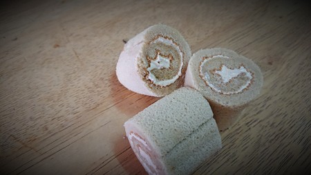 cake roll and coffee on wooden tableの写真素材