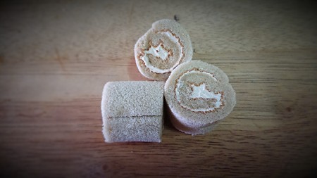 cake roll and coffee on wooden tableの写真素材