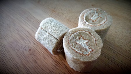 cake roll and coffee on wooden tableの写真素材