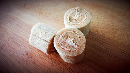 cake roll and coffee on wooden tableの写真素材
