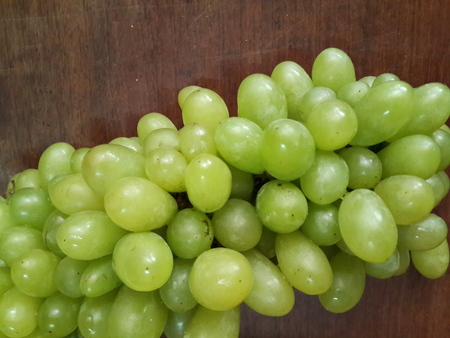 bunch green grapes on woodenの写真素材