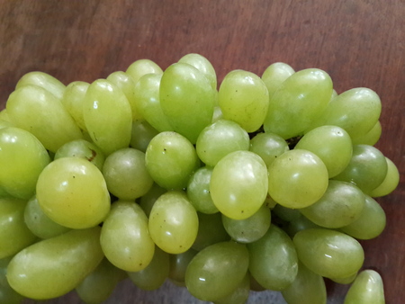 bunch green grapes on woodenの写真素材