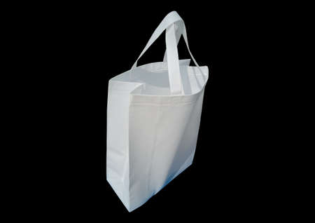 White Color Non Woven ECO Friendly Shopping Bag Isolated on black background. Copy space for text and logoの写真素材
