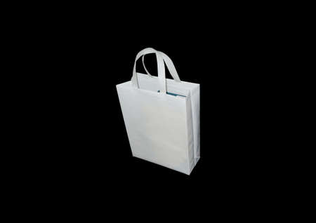White Color Handle Loop Non Woven ECO Friendly Shopping Bag Isolated on black background. Copy space for text and logoの写真素材