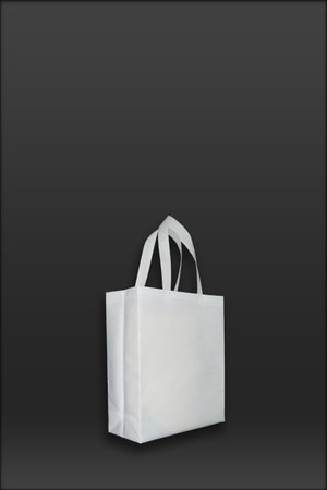 Beautiful White Non Woven grocery shopping bag with black background. ECO Friendly Bag isolated on black background. copy space for text and logo. Use meの写真素材