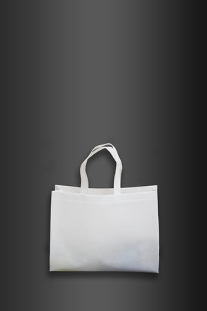Beautiful White Non Woven grocery shopping bag with black background. ECO Friendly Bag isolated on black background. copy space for text and logo. Use meの写真素材