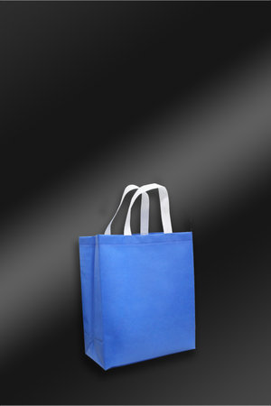 Blue Color Non Woven handle loop grocery shopping bag with black backgroundの写真素材