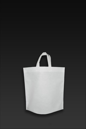 Beautiful White Non Woven grocery shopping bag with black background. ECO Friendly Bag isolated on black background. copy space for text. Use meの写真素材