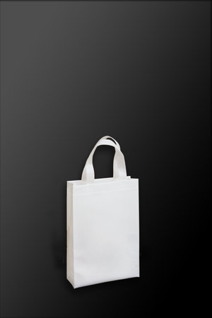 Beautiful White Non Woven grocery shopping bag with black background. ECO Friendly Bag isolated on black background. copy space for text. Use meの写真素材