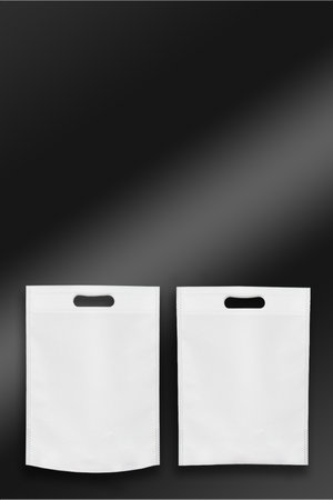 Beautiful White Non Woven grocery shopping bag with black background. ECO Friendly Bag isolated on black background. copy space for text. Use meの写真素材