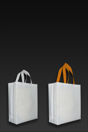 Beautiful White Non Woven grocery shopping bag with black background. ECO Friendly Bag isolated on black background. copy space for text. Use meの写真素材