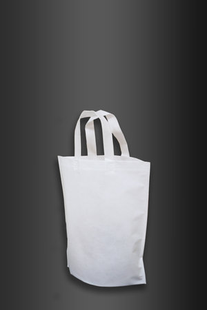 Beautiful White Non Woven grocery shopping bag with black background. ECO Friendly Bag isolated on black background. copy space for text. Use meの写真素材