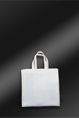 Beautiful White Non Woven grocery shopping bag with black background. ECO Friendly Bag isolated on black background. copy space for text. Use meの写真素材