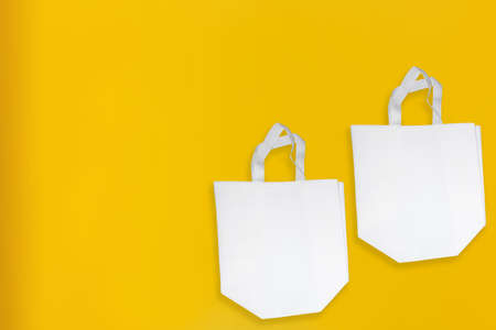 Beautiful Non Woven Grocery Shopping Bag with yellow background. Tote ECO Bagsの写真素材