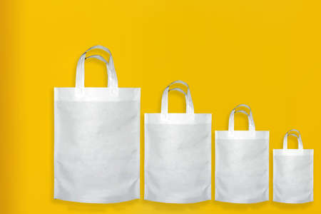 Beautiful Non Woven Grocery Shopping Bag with yellow background. Tote ECO Bagsの写真素材