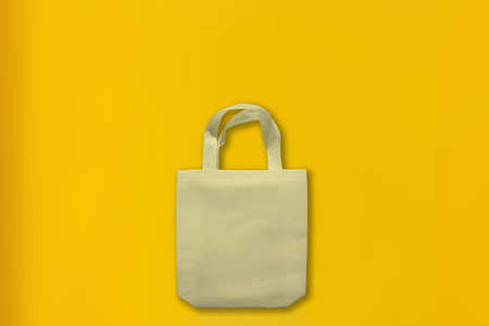 Beautiful Non Woven Grocery Shopping Bag with yellow background. Tote ECO Bagsの写真素材