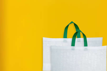 Beautiful Non Woven Grocery Shopping Bag with yellow background. Tote ECO Bagsの写真素材