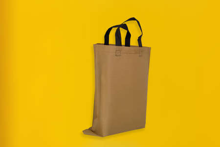 Beautiful Non Woven Grocery Shopping Bag with yellow background. Tote ECO Bagsの写真素材
