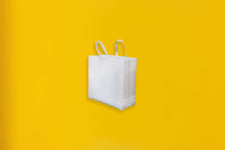 Beautiful Non Woven Grocery Shopping Bag with yellow background. Tote ECO Bagsの写真素材