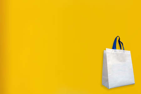 Beautiful Non Woven Grocery Shopping Bag with yellow background. Tote ECO Bagsの写真素材
