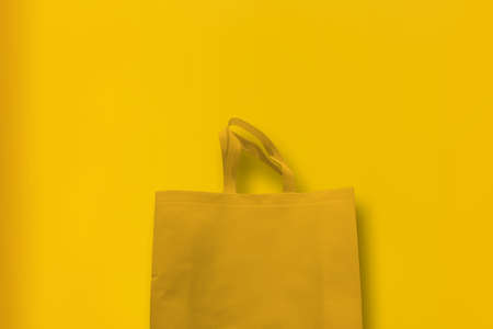 Beautiful Non Woven Grocery Shopping Bag with yellow background. Tote ECO Bagsの写真素材