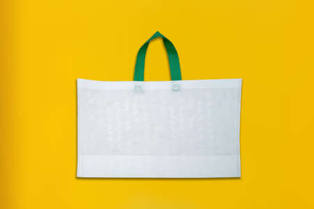 Beautiful Non Woven Grocery Shopping Bag with yellow background. Tote ECO Bagsの写真素材