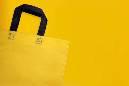 Beautiful Non Woven Grocery Shopping Bag with yellow background. Tote ECO Bagsの写真素材