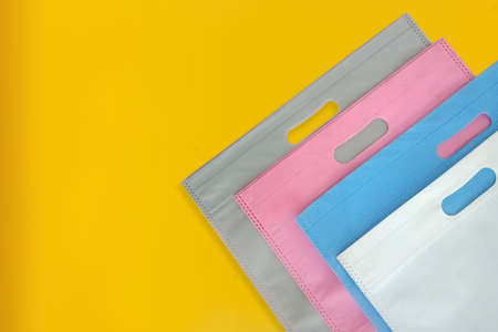 Beautiful Non Woven Grocery Shopping Bag with yellow background. Tote ECO Bagsの写真素材