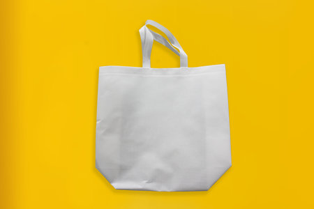 Beautiful Non Woven Grocery Shopping Bag with yellow background. Tote ECO Bagsの写真素材
