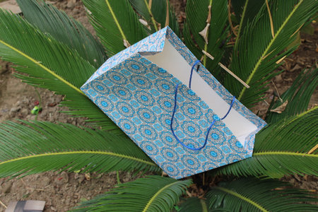 Colorful Paper Shopping bags are isolated on a green natural background. no plastic bags only eco-friendly bags.の写真素材